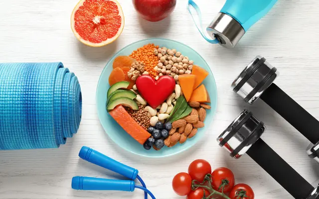Nutrient-dense plate of salmon, lentils, chickpeas, nuts, avocado and blueberries